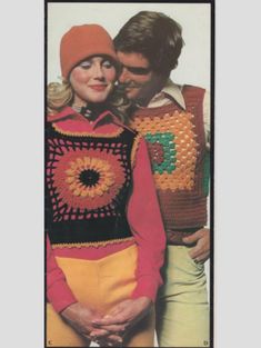 two people standing next to each other wearing crocheted sweaters