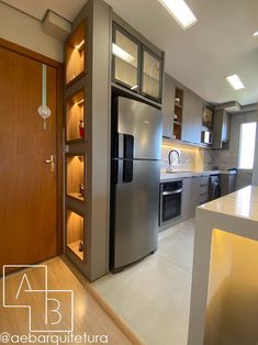 a modern kitchen with stainless steel appliances and cabinets