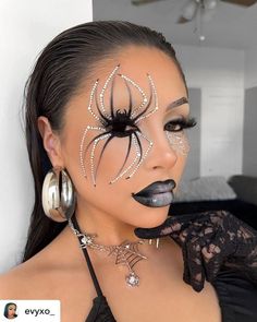 a woman with black makeup and spider web on her face