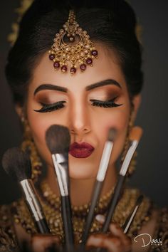 a woman with makeup brushes in her hands