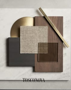 an assortment of different colors and materials on top of a white table with the words tosconovaa written in gold