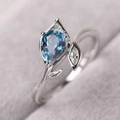 ◆ The ring is handcrafted from sterling silver and decorated with a dazzling 5*7 mm London blue topaz and CZs. It is suitable for engagement/anniversary/daily occasion. ◆ Production Description: Main stone Type: Real London Blue Topaz Main Stone Shape: Pear Cut Main Stone Size: 5*7 mm(0.97ct) Side stone: CZ Metal: 925 Sterling silver - Other options available in the drop down menu ◆ Customization: √Free for Add Engraving √Other Metal Type Available √Other Gemstones & Shapes Available √Person Diamond-accented Topaz Ring As A Gift, Gift Diamond Topaz Ring With Gemstone Accents, Diamond Topaz Ring With Gemstone Accents For Gift, Gift Topaz Ring With Diamond And Gemstone Accents, Silver Blue Topaz Ring With Prong Setting, White Topaz Birthstone Ring Gift, White Gold Topaz Birthstone Ring For Anniversary, Anniversary White Gold Birthstone Ring With Topaz, Silver Blue Topaz Ring With Accent Stones