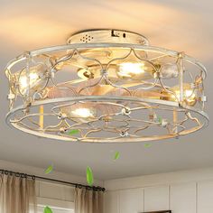 a ceiling light that is hanging from the ceiling in a room with white walls and curtains