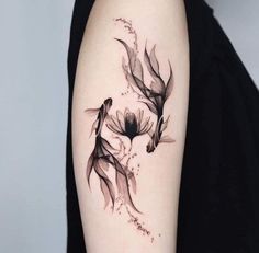 a woman's arm with two black birds on it