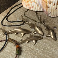 "Great gift for Shark Lovers- The gathering of realistic reef sharks is captured! This shark pendant is sculpted from Artists own personal ocean footage and captures their powerful movement. Choose from several options to hang the pendant from. Pendant is approximately 2\" X 1\". Also available in Key Chain design- https://www.etsy.com/listing/602590309" Shark Trinkets, Sharkcore Outfits, Shark Presents, Shark Items, Ocean Hat, Shark Clothing, Shark Things, Shark Clothes, Shark Outfit