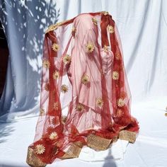 Soft elegant net dupatta with gold shimmer floral work, along with heavy border which has beads all around it. It's ideal for bridal veil, mendi, eid or parties. Measurements; length 214cm, width 110 Colour may vary due to lighting Please be sure before you order as we do not accept return, exchange or cancellations. Red Embroidered Fabric With Sheer Dupatta For Diwali, Gold Organza Churidar With Dupatta, Sheer Dupatta Shawl For Diwali, Festive Gold Embroidered Net Fabric, Traditional Festive Net Churidar, Traditional Net Churidar For Festive Occasions, Bollywood Wedding Shawl With Sheer Dupatta, Net Churidar With Sheer Dupatta For Wedding, Gold Churidar With Sheer Dupatta For Diwali