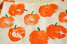 an art project with oranges painted on paper