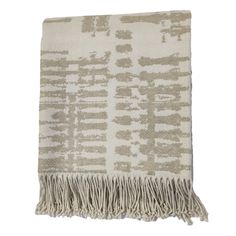 a beige and white blanket with fringes