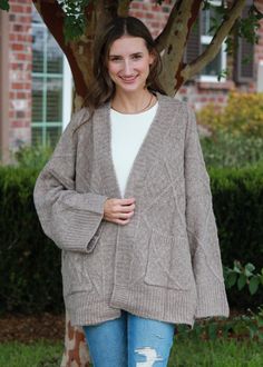 This cozy cardigan features a large sleeve and front pockets. Cardigan is One Size. THIS ITEM IS FINAL SALE Cozy Fall Sweater With Side Pockets, Brown Cardigan For Cold Weather In Fall, Brown Cardigan For Fall And Cold Weather, Cozy Cardigan With Pockets, Cozy Fall Cardigan For Loungewear, Cozy Cardigan For Cold Weather In Fall, Cozy Sweater Coat With Pockets For Layering, Oversized Fall Sweater With Pockets, Cozy Fall Loungewear Cardigan