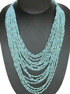 a necklace on a mannequin with blue beads