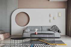 a living room filled with furniture next to a wall mounted round mirror on the wall