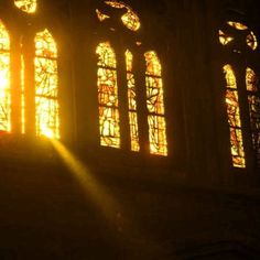 the sun is shining through stained glass windows