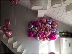 heart shaped balloons are hanging from the ceiling