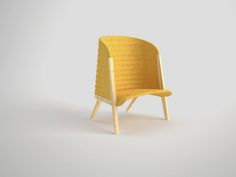 a yellow chair sitting on top of a white floor