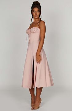 The dreamy Deanna dress is ultra feminine, made in our premium woven cotton blend fabric that feels as good as it looks. With a corseted bodice to cinch the waist, the bust is gathered with a drawstring tie for a super pretty finish. The midi skirt is complete with a thigh high split for a little bit of sexiness. Style it up with an effortless knot and heeled mules.



Colour: Blush.

Premium woven cotton blend fabric.



Corseted bodice.

Gathered bust.

Drawstring at the bust.

Thigh high spli Pink Midi-length Corset Dress, Luxury Romantic V-neck Midi Dress, Chic Pink Midi V-neck Dress, Luxury Pink A-line Midi Dress, Pink V-neck Midi Dress With Gathered Sleeves, Homecoming Dresses Corset, Midi Dress Wedding Guest, Long Sleeve Homecoming Dresses, Homecoming Dresses Long