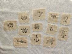 a towel with embroidered images of different things on it, including an anchor, fish, seagull, and other items