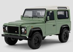 a green and white land rover vehicle on a gray background