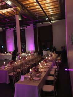 the tables are set up with candles and place settings for dinner or other function guests