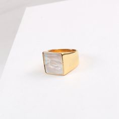 This 18K Gold Plated Large Square Mother-of-Pearl Ring is a luxurious, statement-making piece. Featuring a chunky gold band with both mother-of-pearl and black onyx accents, it's the perfect unique gift for any special occasion. This signet ring is also an ideal stacking ring for daily wear. [MATERIAL]: Yellow brass with real 18k gold plated. Our ring will not tarnish or turn green.[PLEASE NOTE]: Each shell color is unique so the shade and color might slightly vary. Elegant Gold Rings With Mother Of Pearl, Gold Mother Of Pearl Ring As A Gift, Gold Mother Of Pearl Rings For Anniversary, Gold Mother Of Pearl Anniversary Rings, Gold Mother Of Pearl Ring For Gift, Modern Gold Jewelry With Mother Of Pearl, Clean Sterling Silver, Shell Color, Wide Band Ring