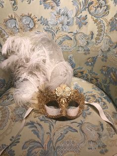 "This mask with feathers belongs to our collection of masks \"Lady Plumes\". The fetaher masks are the most elegant, refine and stunning masks of our collections. This mask is a traditional and original papier-mache Venetian mask, handmade and decorated in our Atelier in Venice using Burano Lace,gold leaf, Swarovski, feathers, different trimming. It is perfect for any masquerade party, Halloween costume, pro or event in Venice or elsewhere during Carnival. This mask can be gently bent to form to Floral Mask Masquerade Ball, Masquerade Mask Aesthetic, Venice Mask Carnival, Masquerade Fashion, Burano Lace, Gold Masquerade Mask, Royalty Core, Venetian Masquerade Masks, Venice Mask