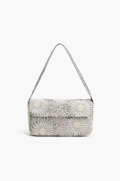 Hand beaded Small Shoulder Bag Fully Embellished in White Foliage Pattern Fully Lined Interior with Zip Pocket Embellished Shoulder Strap Magnetic Button Closure Size: 10" x 5.5" x 2" Handmade by Artisans The Ivory Petal Frostwork Shoulder Bag is an exquisite accessory that exudes elegance and sophistication. Crafted with meticulous attention to detail, this shoulder bag features delicate hand-beaded embellishments in a mesmerizing white foliage pattern. The intricate design adds a touch of ethe Luxury Beaded Beige Shoulder Bag, Small Beaded Bag, Beige Beaded Shoulder Bag, Artisan Clothing, Beaded Shoulder Bag, Beaded Embellishments, Leopard Bag, Tambour Embroidery, Floral Purse