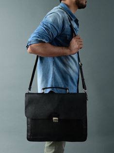 Our Sleek Black Attache Laptop Bag combines style with functionality. Crafted from robust buffalo leather, it exudes durability and sophistication. The metal clasp closure ensures secure storage, while the canvas lining adds sturdiness. There's a large main compartment along with other small compartments for keeping your belongings organized. With ample space, it comfortably accommodates a laptop, books, and files, making it perfect for office meetings or offsite outings. Elevate your profession Italian Bags, Office Meeting, Buffalo Leather, Laptop Bag, Messenger Bag, Buffalo, Black Leather, Laptop, Sleek