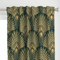 a green and gold patterned curtain hanging on a window sill in front of a white wall