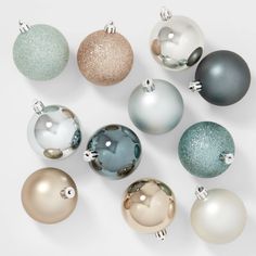 a bunch of different colored ornaments on a white surface