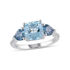 This amazing cocktail ring features a cushion-cut sky blue topaz center stone 2.50 carats (ctw) and supported by heart shaped london blue topaz side stones 0.96 carats (ctw) with six ascending round white accent diamonds set in sterling silver. This exquisite ring is enhanced with a high polish finish. 3.50 Carat (ctw) Blue Topaz Ring in Sterling Silver with Accent Diamonds Size: 8.  Gender: female.  Age Group: adult. Diamond Fashion Rings, Silver Jewels, Sky Blue Topaz, Fashion Ring, Blue Topaz Ring, Diamond Fashion, London Blue Topaz, Topaz Gemstone, London Blue