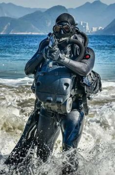 a man in scuba gear walking into the ocean