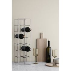 the wine rack is holding several bottles and glasses