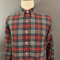 "You are viewing a classic Vintage Men's Button-Down Shirt by Polo/Ralph Lauren c1990s. This great looking shirt is made of a medium weight all cotton cloth in a fantastic plaid in red, blue, green, yellow and white. Details include button-down collar, embroidered blue Polo logo at left side of chest, 7 button placket (with pearlized white plastic buttons), long sleeves with single buttoned cuffs and one button up the hem, slightly rounded hem (longer in the back). Dates from likely the mid to l Classic Plaid Shirt With Buttons, Classic Collared Flannel Shirt With Button Closure, Polo Logo, White Details, Button Down, Un Logo, Men's Button Down Shirt, Blue Polo, Mens Plaid