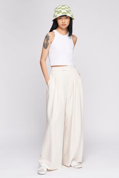 Previously known as the Relaxed Pleated Trouser. A breezy wide-leg trouser that exudes effortless elegance. Designed with a flattering high waist and multiple pleats for added volume, the Plaza Trouser is a statement pant that’s easily dressed up or down. Pleated Pants Outfit, Slow Fashion Clothes, Statement Pants, Tailoring Details, Minimalist Capsule Wardrobe, White Trousers, Silk Trousers, Conscious Fashion, The Plaza