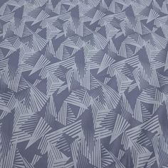 an abstract pattern is shown in grey and white colors on a bed sheet that has been made into a pillow