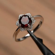 Garnet Floral Wedding Ring Round Cut Sterling Silver January - Etsy Solitaire Flower Promise Ring, Round Ruby Flower Promise Ring, Elegant White Gold Flower Ring With Birthstone, Fine Jewelry Garnet Birthstone Ring, Garnet Birthstone Ring For Anniversary, Garnet Birthstone Ring With Prong Setting, Round Garnet Ring With Halo Setting, Silver Garnet Birthstone Ring With Center Stone, Anniversary Garnet Birthstone Ring