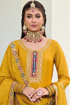 This Mustard color Party Wear Palazzo Salwar Suit flaunts sophistication with zari, resham, badla, and sequence work along the kameez. Accented by a baluming chinnon silk embroidered palazzo bottom, santoon lining, and sequence embroidered baluming chinon silk dupatta, this ensemble is perfect for weddings and other special events. Final sale Kameez baluming chinon silk with heavy embroidery & sequin work Sharara baluming chinon silk with heavy embroidery front and back Dupatta baluming chinon s Festive Semi-stitched Straight Kurta Salwar Kameez, Traditional Gold Palazzo Set With Zari Work, Gold Semi-stitched Palazzo Set For Festive Occasions, Festive Kundan Sets With Resham Embroidery, Designer Kundan Palazzo Set With Mirror Work, Gold Palazzo Set With Zari Work For Festive Occasions, Festive Gold Palazzo Set With Zari Work, Gold Bollywood Palazzo Set With Zari Work, Designer Embroidered Banarasi Silk Palazzo Set