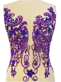 the back of a purple and blue beaded corset on a mannequin