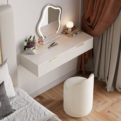 a white dressing table with a mirror and stool next to a window in a bedroom