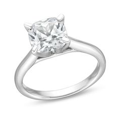 a white gold ring with a princess cut diamond in the center, on a white background