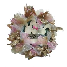 a pink and white wreath with the word welcome