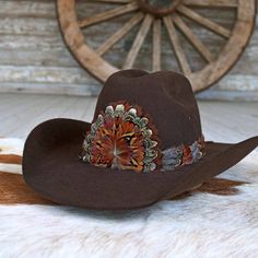 The Rowan Western Feather Hat Band, Short, is specially crafted for smaller-sized hats (6 7/8 and under) and kids' hats. Made from 100% feather, it has an approximate length of 53 cm (excluding leather ties) and a width of 2 cm. The crest measures 4" W x 3.25" H, adding a distinctive and elegant touch to the design. Adjustable with leather ties, this hat band ensures a secure fit while providing a stylish western accent for smaller hats. Brown Curved Brim Top Hat For Ranch, Brown Top Hat With Curved Brim For Rodeo, Western Style Brown Top Hat With Curved Brim, Brown Wide Brim Top Hat For Ranch, Brown Top Hat With Curved Brim For Western-themed Events, Brown Curved Brim Top Hat For Western-themed Events, Brown Hat Bands With Feathers For Western-themed Events, Brown Wide Brim Top Hat For Rodeo, Brown Top Hat For Country Events With Short Brim