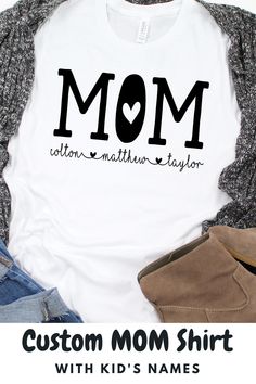 Super cute, unisex shirt with the word, "Mom" and kid's names below with adorable hearts. Great t-shirt for a Mom birthday gift, Mother's Day gift, baby shower gift, or a New Mom gift. #shirtformom #personalizedmomshirt #personalizedmomgift #momshirtwithnames #momshirtwithkidsnames #custommomshirt #babyshowergiftideas #newmomgiftideas #bestmomgift #mombirthdayshirt Family Matching Cotton T-shirt Gift, Cotton T-shirt With Name Print For Family Events, Family Matching Custom Name Cotton T-shirt, Custom Name Cotton T-shirt For Family Matching, Cute T-shirt With Name Print For Gift, Family Matching Cotton T-shirt With Custom Name, Personalized Casual Tops For Mother's Day, Casual Personalized Tops For Mother's Day, Personalized White Top With Name Print