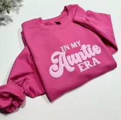 Treat yourself or gift to a timeless classic with this In My Auntie Era Sweatshirt. The embossed design adds structure and dimension to create a look to cherish for years to come. Make a statement and stay warm in style! How to order 1-Pick your size & color sweatshirt 2- Add to cart 3- In the instructional box enter the color you want for your design(see picture for reference) Example: white Sweatshirt Design Ideas Vinyl, Sweater Designs For Women Vinyl, Cricut Sweatshirt, Iron On Sweatshirt Ideas, In My Christmas Era, Auntie Era, Vinyl Sweatshirt Ideas, Aunt Sweatshirt Ideas, Auntie Sweatshirt Ideas