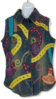 NWT Chico's Denim Embroidered, Beaded, and Sequin Vest.  Size - 1 (Medium).  This vest is very Colorful and has an Abstract Pattern.  Vest has a full button front and point collar.  Also has a rounded hem.  Please see photos.  Ships USPS Priority Mail Padded Flat Rate Envelope. Actual Measurements (Approximate) Arm Pit to Arm Pit -19.5" Length - 25" Fitted Embroidered Denim Vest Casual, Casual Embroidered Fitted Denim Vest, Spring Fitted Beaded Vest, Fitted Beaded Vest For Spring, Spring Beaded Fitted Vest, Applique Jacket, Pattern Vest, Sequin Vest, Wearable Art Clothing