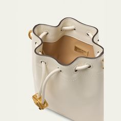 Jimmy Choo "Bon Bon" north-south bucket bag in shiny calfskin leather and brass Detachable crossbody strap Drawstring closure  Approx. 6"H x 4"W x 6"D Made in Italy Leather And Brass, Mini Bucket Bag, Mini Bucket Bags, Mini Bucket, North South, Bon Bon, 6 D, Crossbody Strap, Jimmy Choo