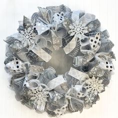 a christmas wreath with silver and white decorations