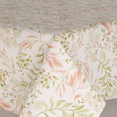 an image of a table cloth with flowers and leaves on the top, in pastel colors