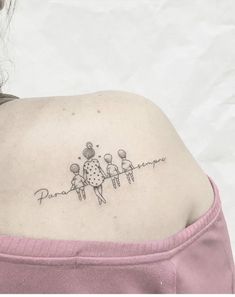 a woman's back shoulder tattoo with three people holding hands and the word paraphernalia written in cursive font