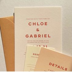 the wedding stationery is laid out on top of each other, including an envelope