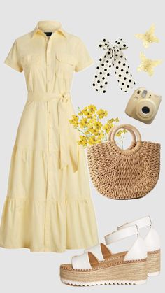 a yellow dress with black sandals and a straw bag on the floor next to it